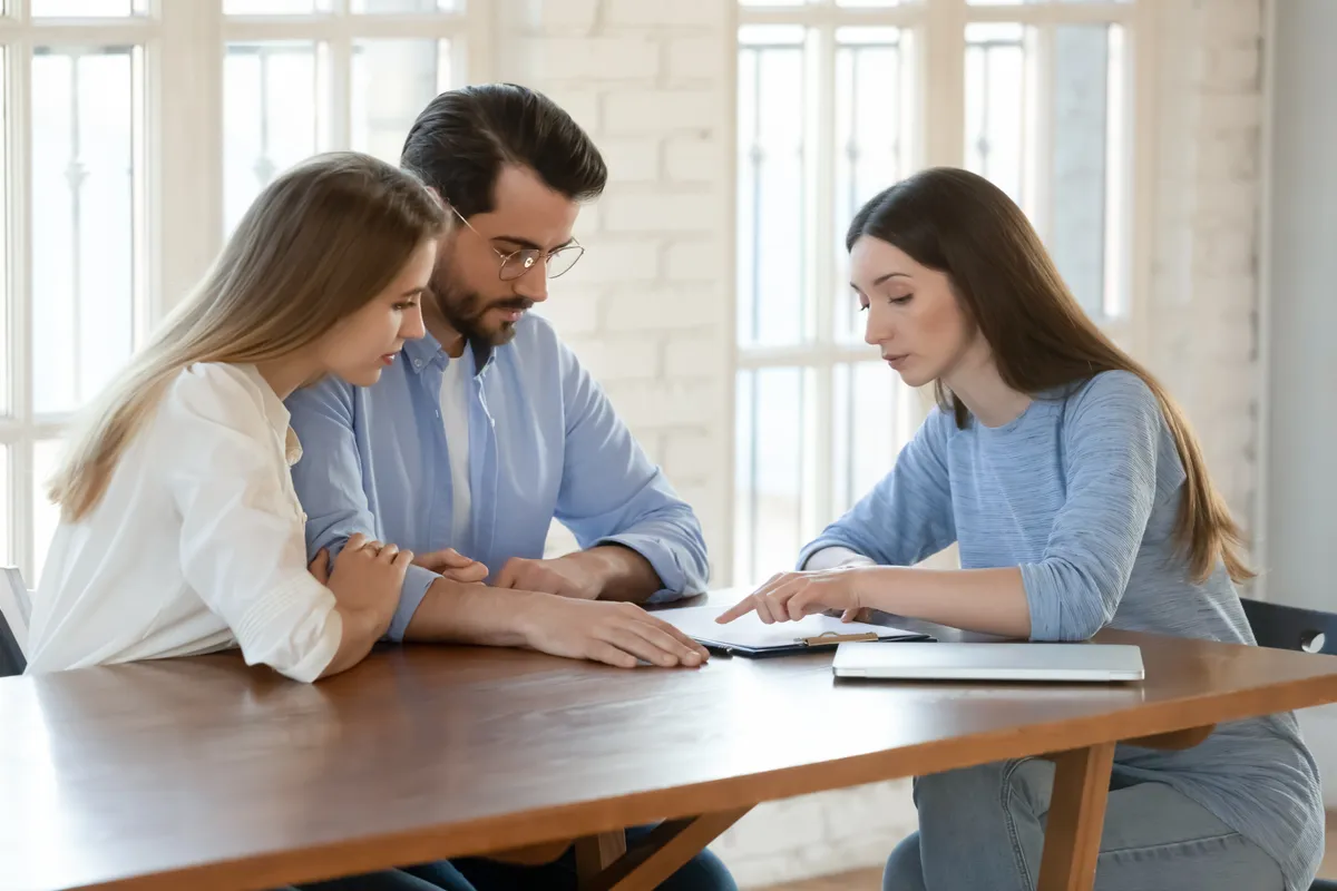 Business owners reviewing financial documents with a professional